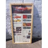 A large pictorial cardboard advertisement for the Camaro motor car, framed and mounted for