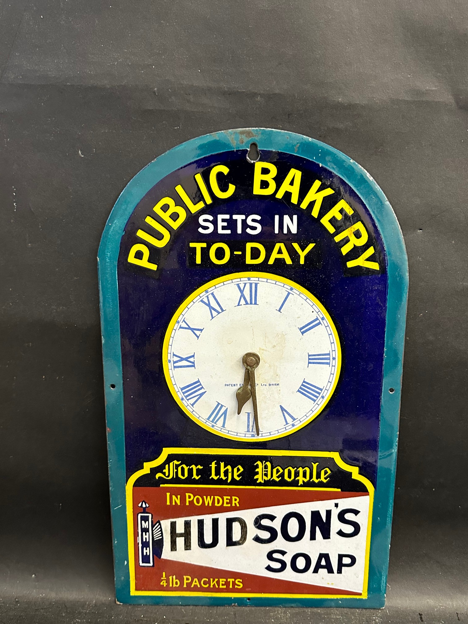 A Hudson's Soap, Public Bakery enamel clock with searchlight motif, by Patent Enamel, some older