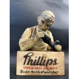 A Phillips Stick-A-Soles and Heels ruberoid advertising figure, 8" w x 11" h x 4" d.