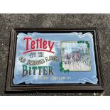 A reproduction advertising mirror for Tetley Bitter, 36 x 25".