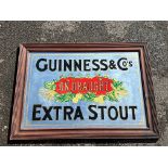 An advertising mirror for Guinness & Co's Extra Stout, an older reproduction, 37 x 27".