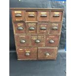 An early 20th Century bank of 13 pine drawers, as used for dispensing seeds, 28" w x 33" h x 10" d.