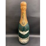 An oversized shop display advertising champagne bottle, 32" h.