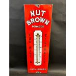 An enamel thermometer sign advertising Nut Brown Tobacco, 7 1/2 x 22 1/2".