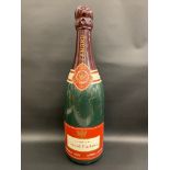 An oversized shop display advertising champagne bottle, 32" h.