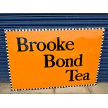 A large Brooke Bond Tea rectangular enamel sign by Patent Enamel, mounted on a wooden frame behind