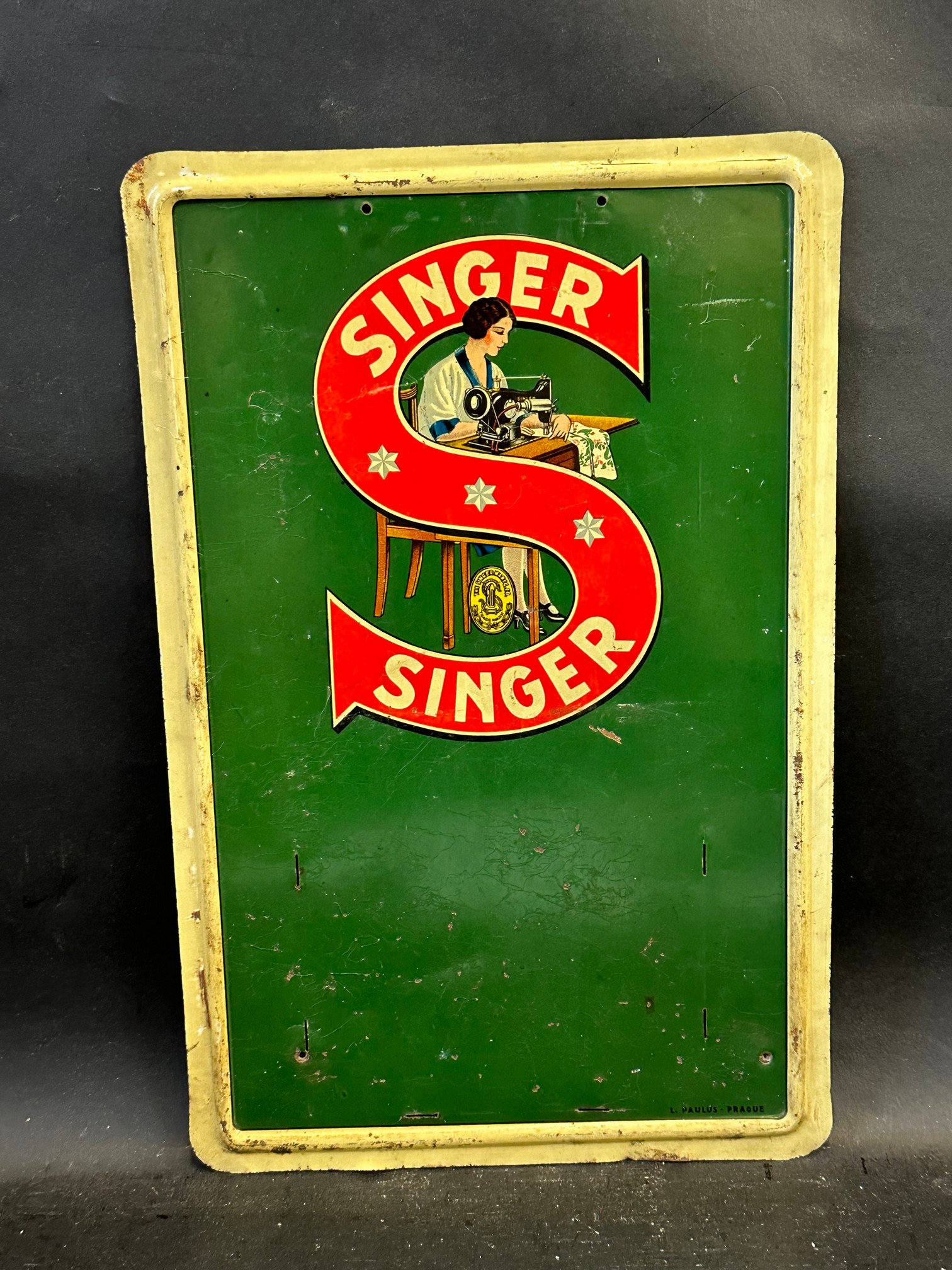 A small Singer Sewing Machines tin sign with four slots, 9 1/2 x 14 3/4".