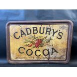 A Cadbury's Cocoa embossed tin advertising sign with cocoa pods to the centre, 28 1/2 x 19 1/2".