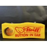 A plastic lightbox advertisng Steiff 'Button In Ear', 20" wide x 7 1/2" high x 3" deep.