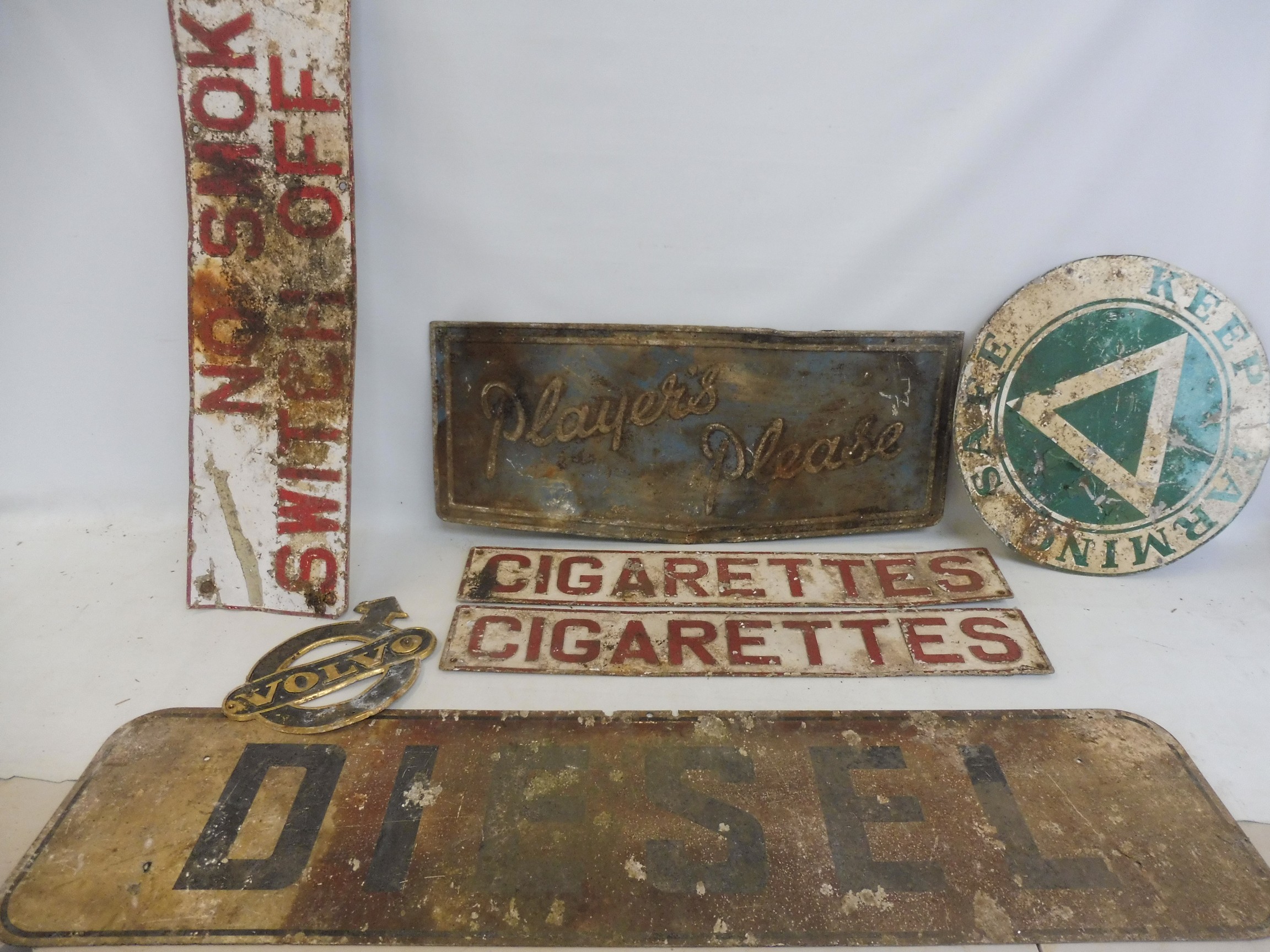 A selection of assorted garage signs including Players Please, No Smoking etc.