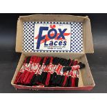 A counter top box dispensing and advertising Fox Laces.