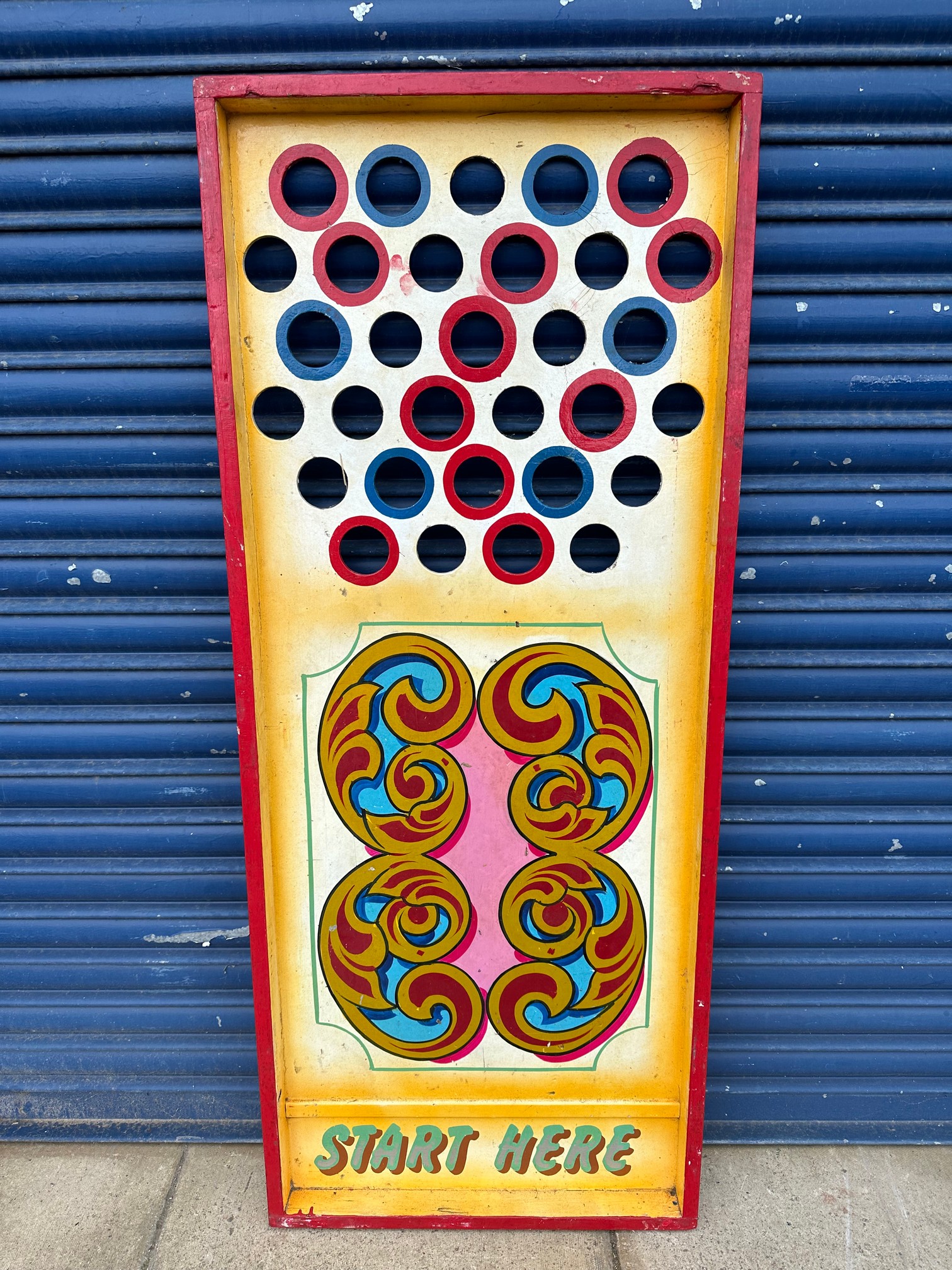 An original roll-down game in original paint with scroll work and lettering.