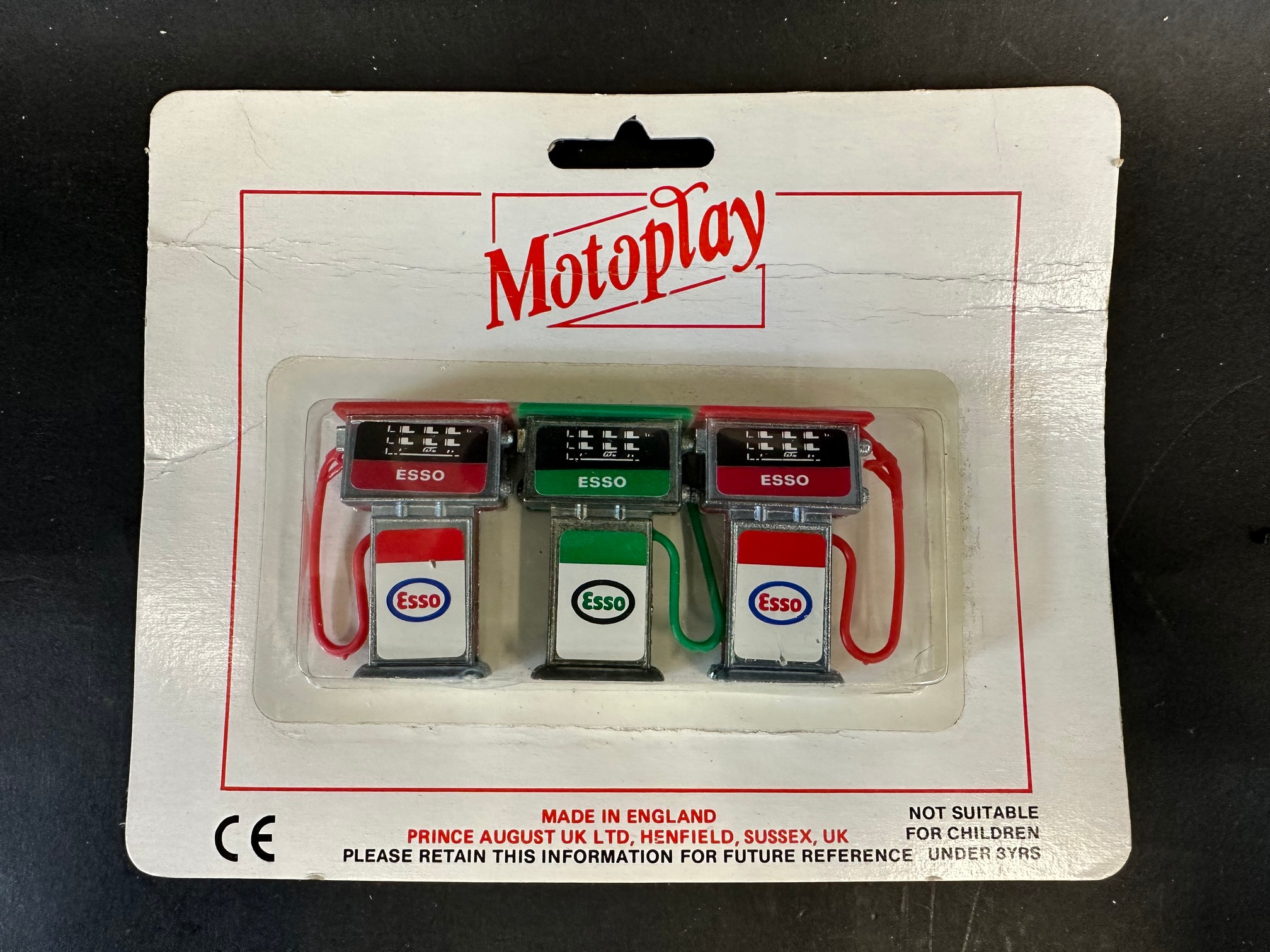 A Motoplay set of three petrol pumps on original card, Made in England.