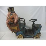 A novelty fairground ride in the form of a stylised car with an elephant clinging on to the back.