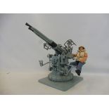 A G. I. Joe action figured in WWII style dress with American Anti-Aircraft gun.