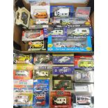 A collection of approximately 25 boxed assorted scale die-cast ambulance and emergency vehicle