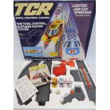 An Ideal made TCR Total Control Racing three car lighted system slot car racing set with cars.