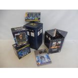 A selection of Doctor Who merchandise including CDs in cases.