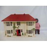 A 1950s tinplate dolls house with accessories with baby doll.