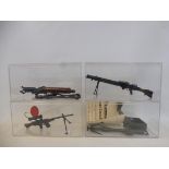 Three Action Man heavy machine guns plus a rope launcher with paperwork, all in protective cases and