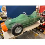 A large fairground racing car in the form of a Lotus in British Racing Green.