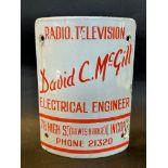 A curved post-mounted enamel sign advertising a Lincoln-based radio and television electrical