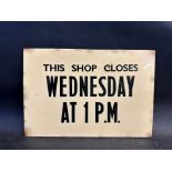 A rectangular celuloid advertising sign 'This Shop Closes Wednesday at 1 p.m., 12 1/4 x 8 1/4".