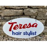 An acrylic oval shop window sign advertising 'Teresa hair stylist', 25 x 14".