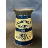 A Cadbury's Dairy Milk Chocolate churn-shaped tin, 9" high.