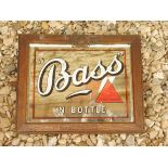 A Bass in bottle oak framed advertising mirror, the original frame stamped and bearing copper coat