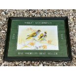 A framed and glazed Wills's Woodbines showcard depicting two budgerigars, in original stamped frame,