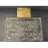 A bronze plaque for J.R. Downing Ophthalmic Optician, 19 3/4 x 12 1/4" plus a small brass name
