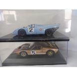 A 1:18 scale Racing Legends Ford G148 Mk. 11 and a Porsche 917.