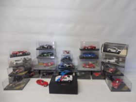 A selection of cased die-cast racing models to include Ferrari, Lotus and Aston Martin.