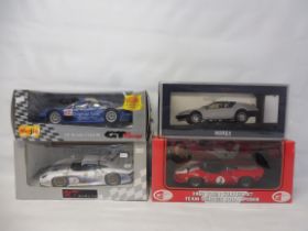 Four boxed die-cast cars 1.18 scale, to include a 1967 John Surtees and a Lola Spyder car.