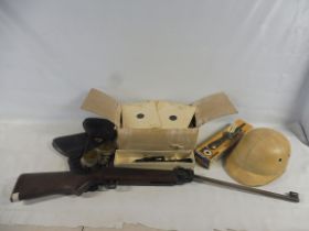 A box of various collectables to include a playworn air rifle, a boxed scope, targets and more.