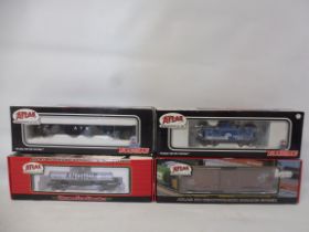 Atlas - four boxed pieces of rolling stock.