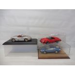 Three boxed die-cast cars to include Porsche Boxster, a Porsche 911 and a Renault Alpine.