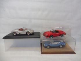 Three boxed die-cast cars to include Porsche Boxster, a Porsche 911 and a Renault Alpine.