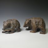 A small Black Forest style strolling Bear, carrying a salmon, 17cm long, together with a larger