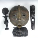 Four pieces of Tribal Art, including three masks and a wooden fertility statue (4)