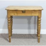 A pine Side Table, the rectangular top above a central frieze drawer, raised on turned legs, W