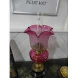 A Victorian brass and cut glass Oil Lamp, having a cut cranberry glass font and etched glass