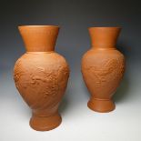 A pair of Japanese Tokoname red stoneware Vases, the stipple ground body decorated in relief with