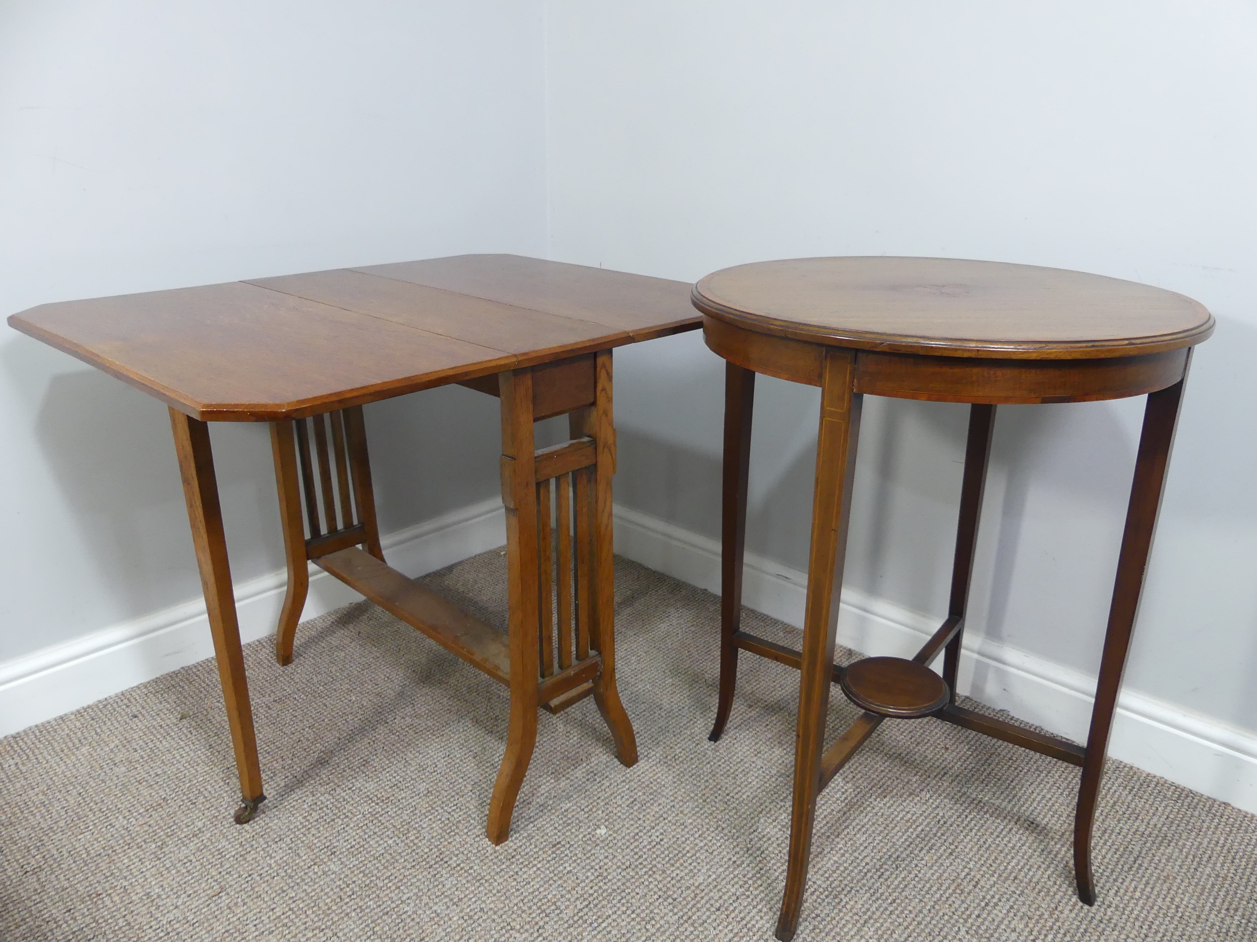 An Edwardian oak Sutherland table, with canted corners to the rectangular top mounted on square