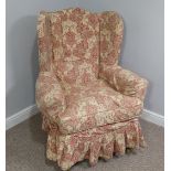 An early 20thC oak framed wing Armchair, with patterned upholstery, the wings above outswept arms,
