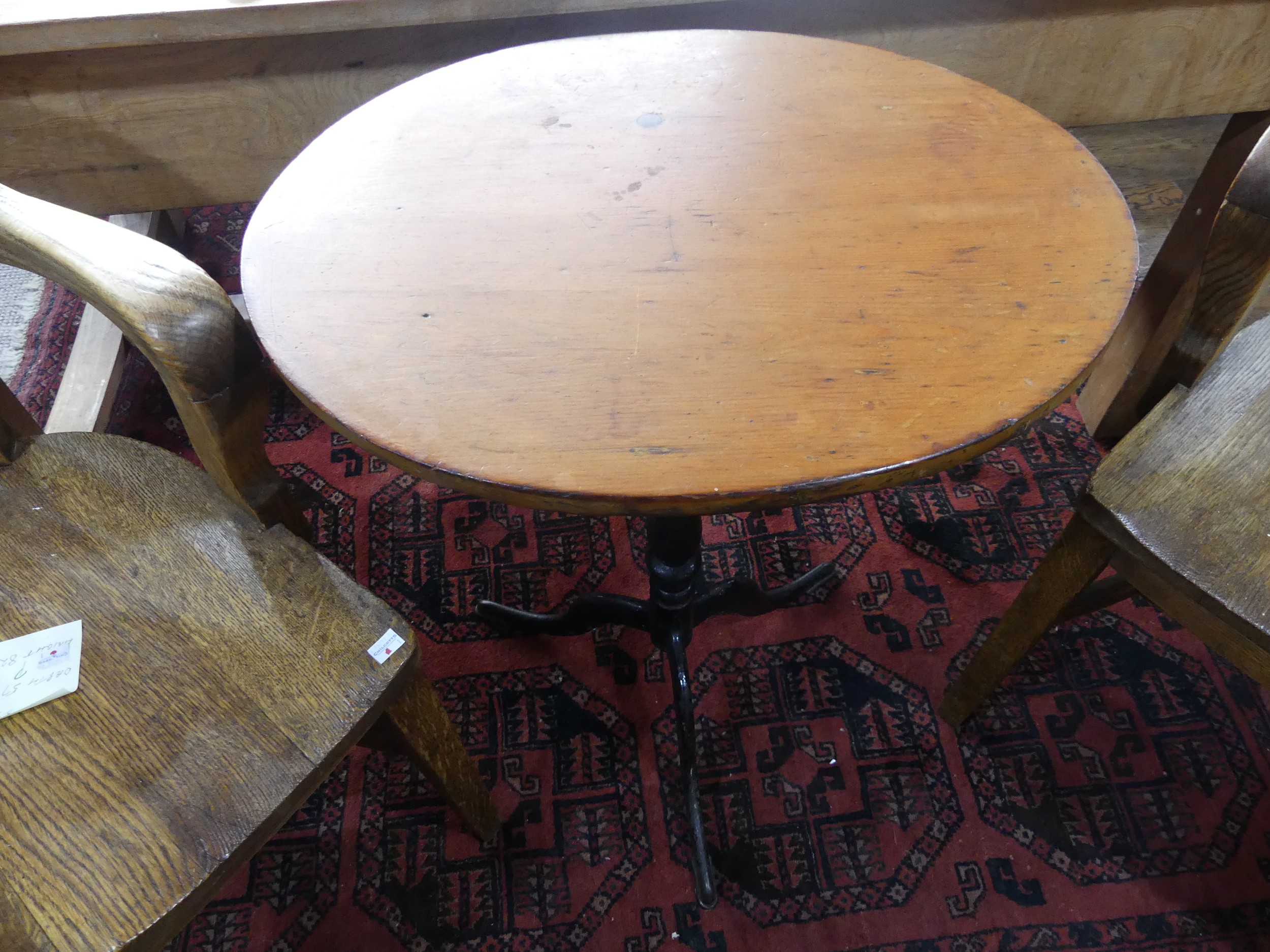 A 19thC pine oval tripod Table, with black painted cast iron base, W 54cm x D 44cm x H 71cm.