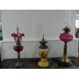 A Victorian brass column Duplex Oil Lamp, having a painted opaque pink font and Duplex burner,