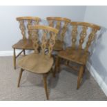 A set of four vintage ash kitchen chairs, all with carved backs, one chair has a different shaped