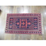 Tribal rugs; an Afghan Rug, hand-knotted with geometric designs on a red ground, 100% wool, in